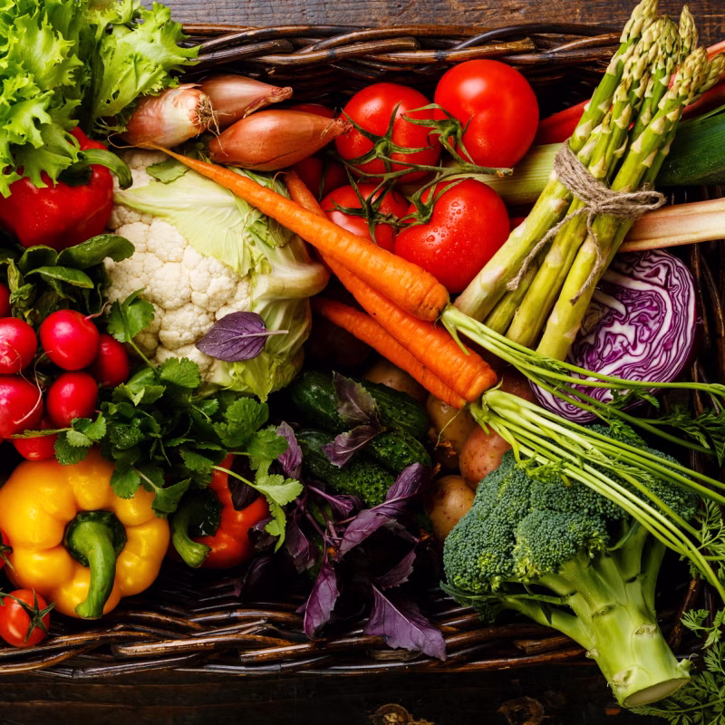 fresh-vegetables-in-basket-on-wooden-background-royalty-free-image-1676394780